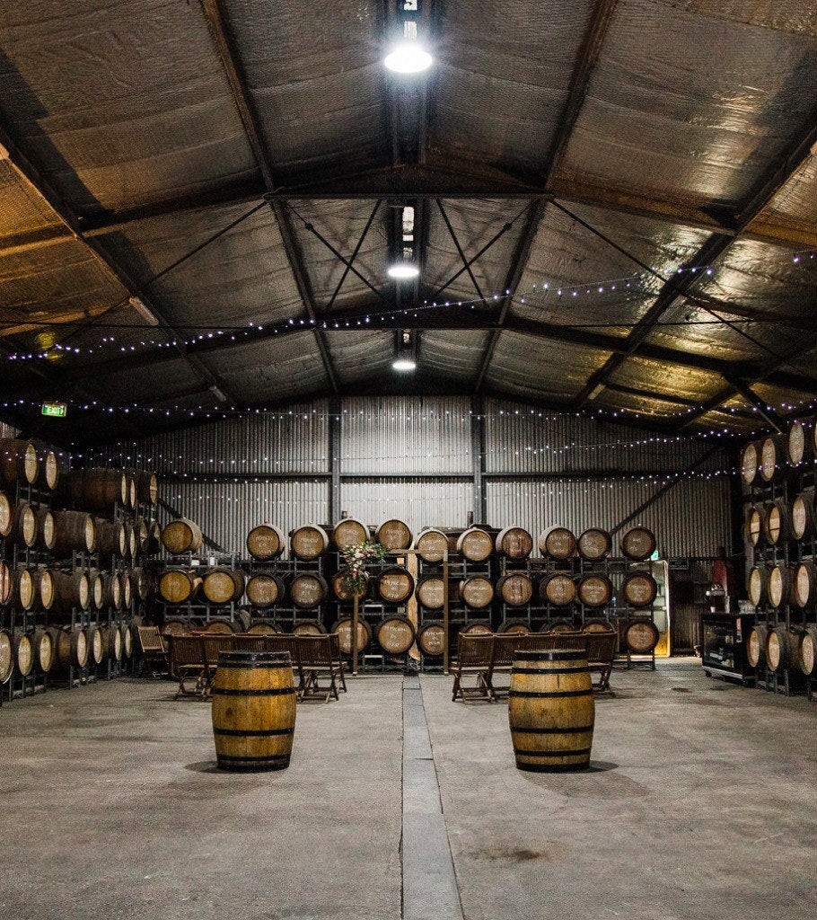 Large wine barrel room setup for a wedding reception.
